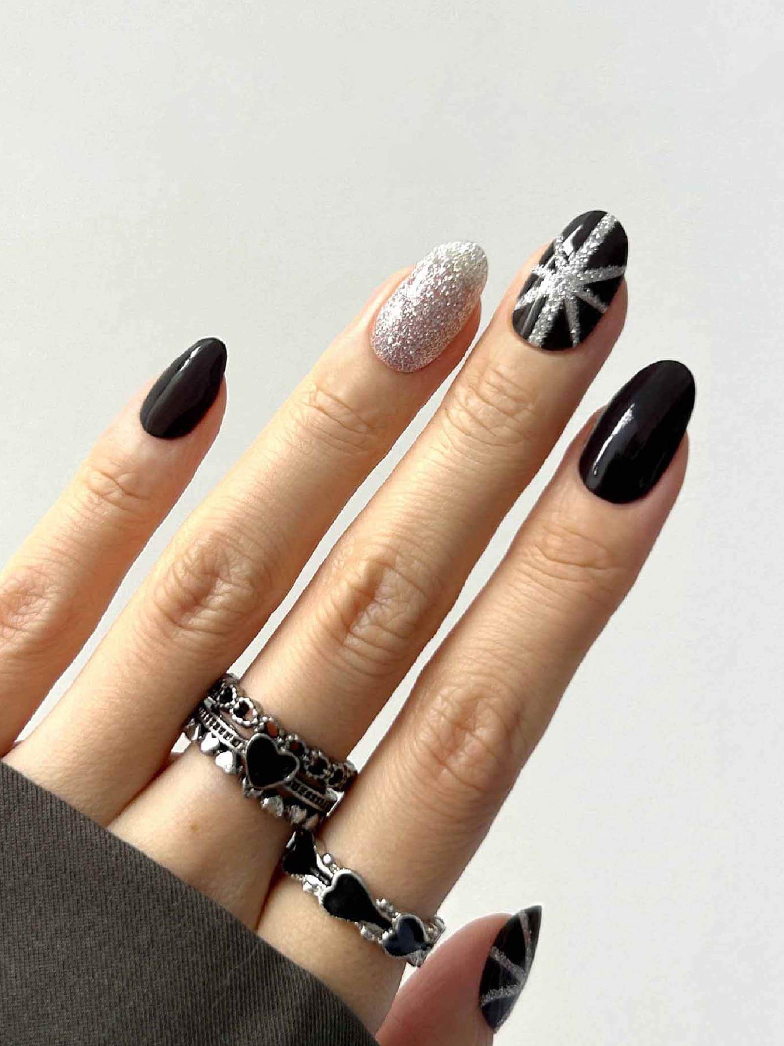 Striking black gel nail stickers with silver glitter art