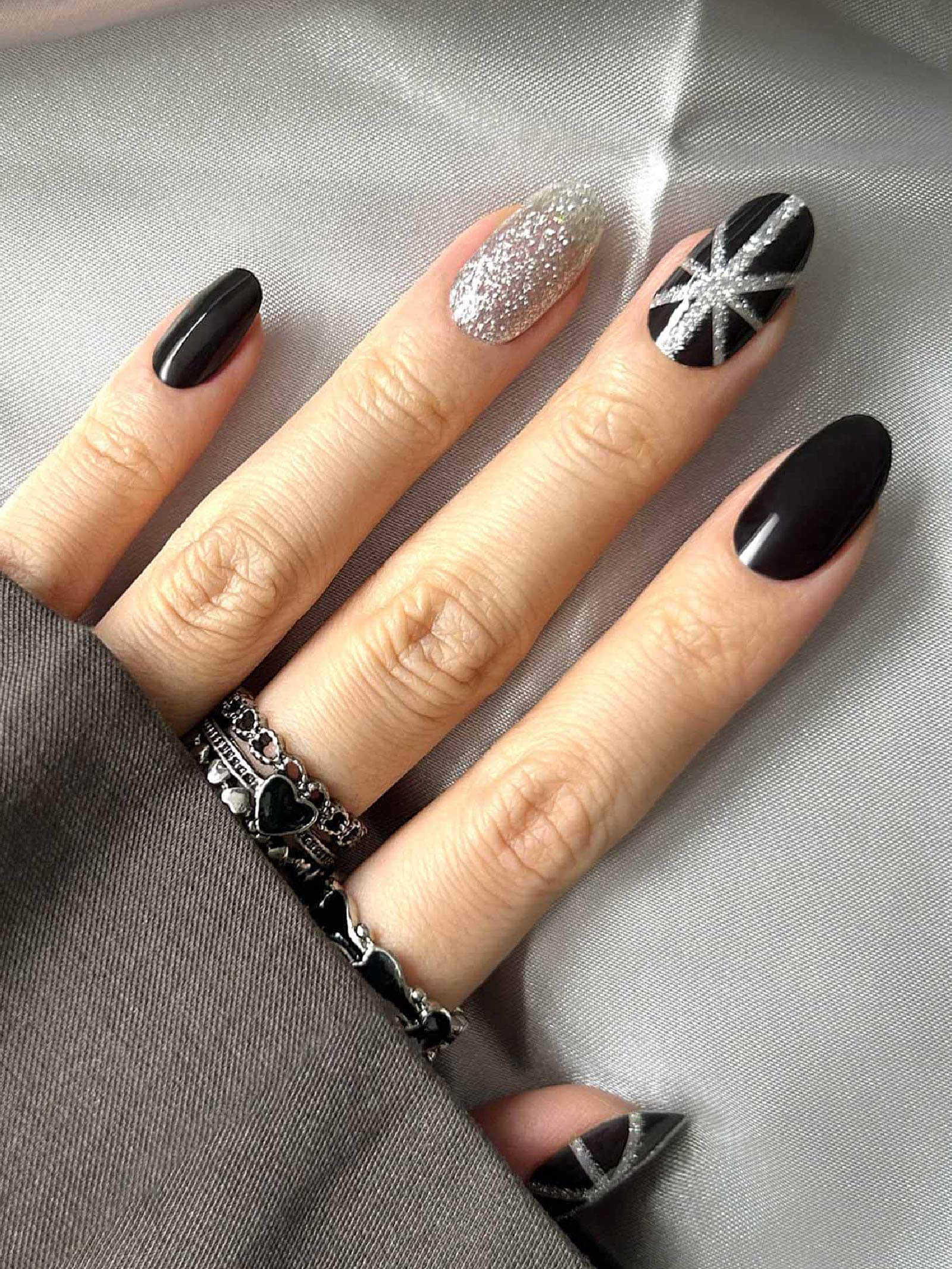 Bold black gel nail stickers with silver glitter art accents