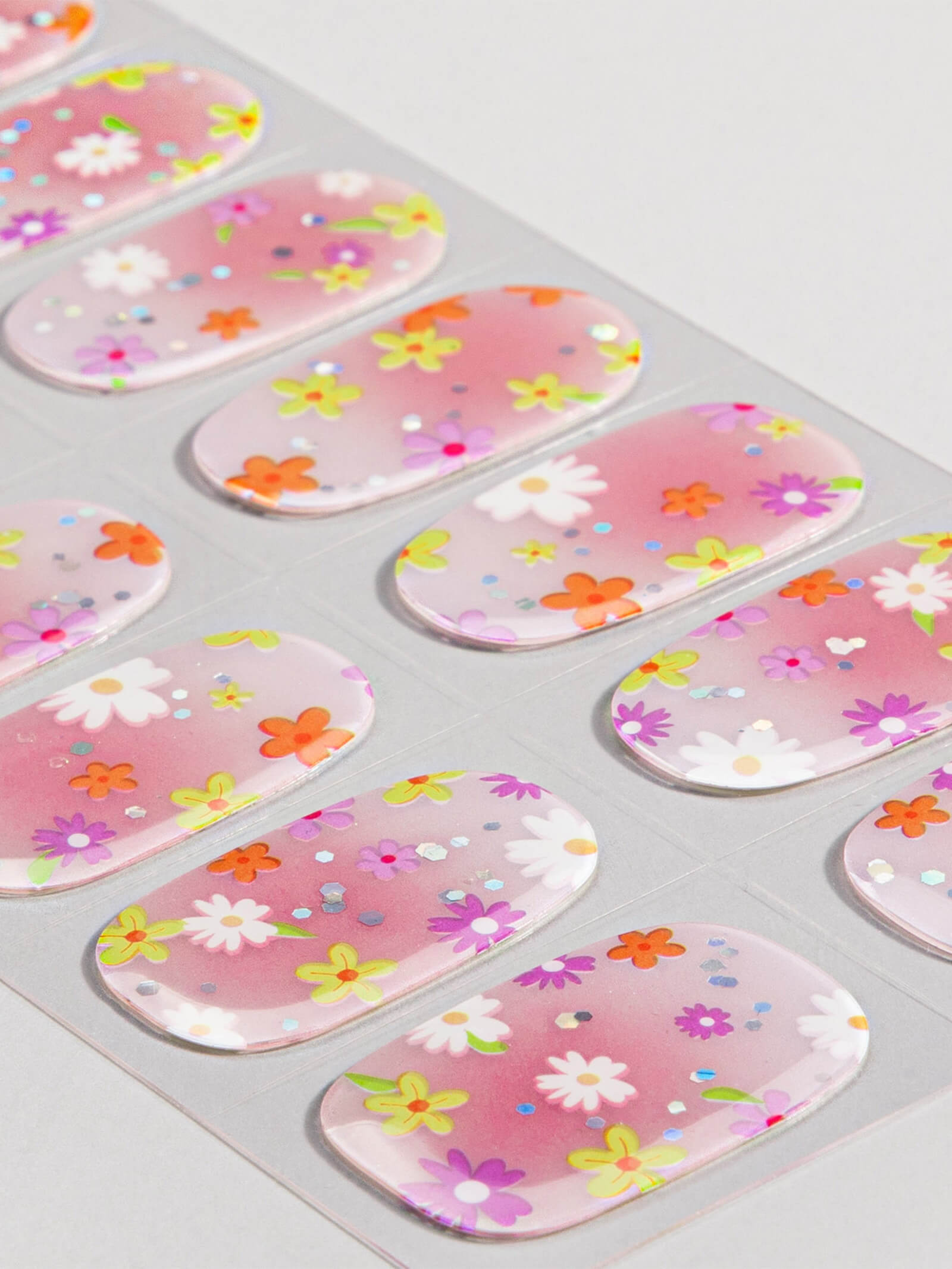 Charming pink ombre nail stickers with bright floral accents