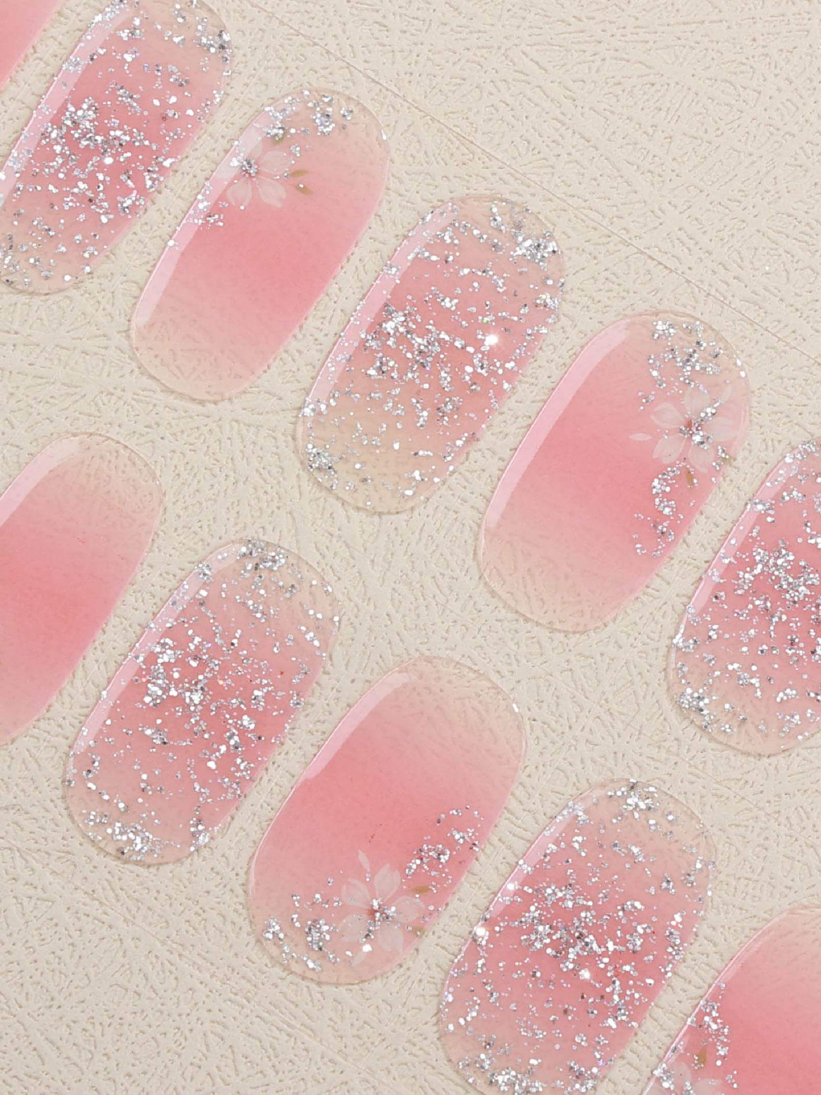 Romantic pink gel nail stickers featuring white floral patterns