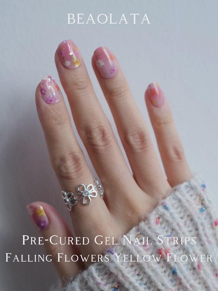 Soft pink gradient nail stickers adorned with colorful flowers